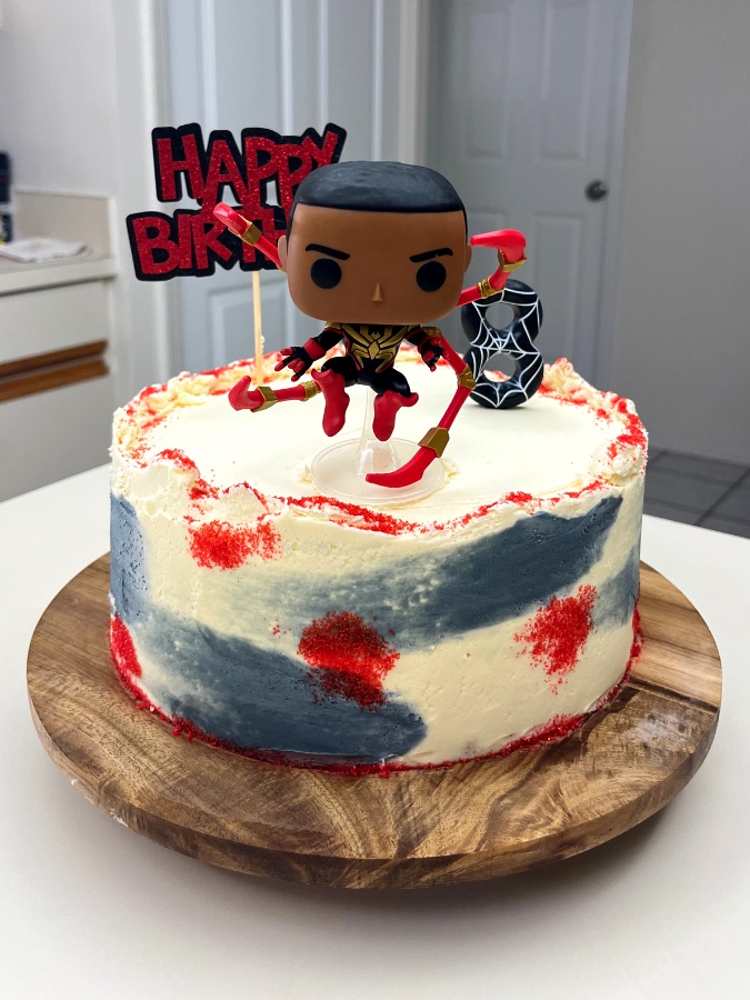 Painterly red, white, and blue buttercream cake with a Spider-Man figurine
