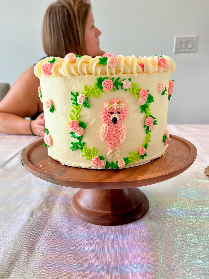 Petite white buttercream cake decorated with piped pink roses